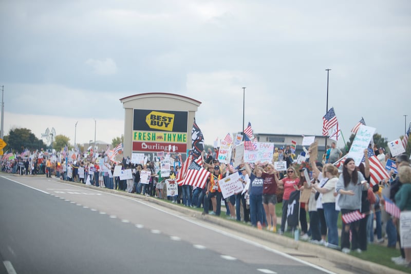 Locals gather at the NO Kings rally along Randall Rd. on Saturday, Oct.18,2025 in Geneva.
