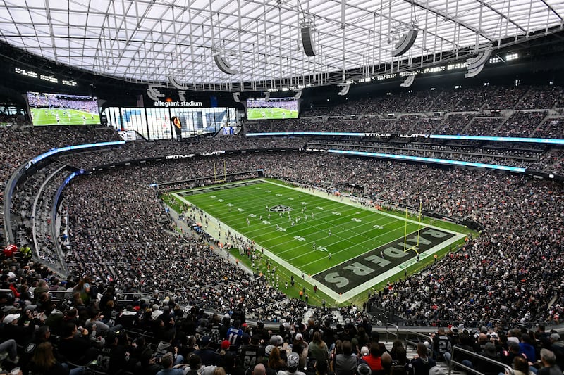 Spectators in Allegiant Stadium watch a play during the first half of an NFL football game between the New England Patriots and Las Vegas Raiders, Sunday, Dec. 18, 2022, in Las Vegas. (AP Photo/David Becker)