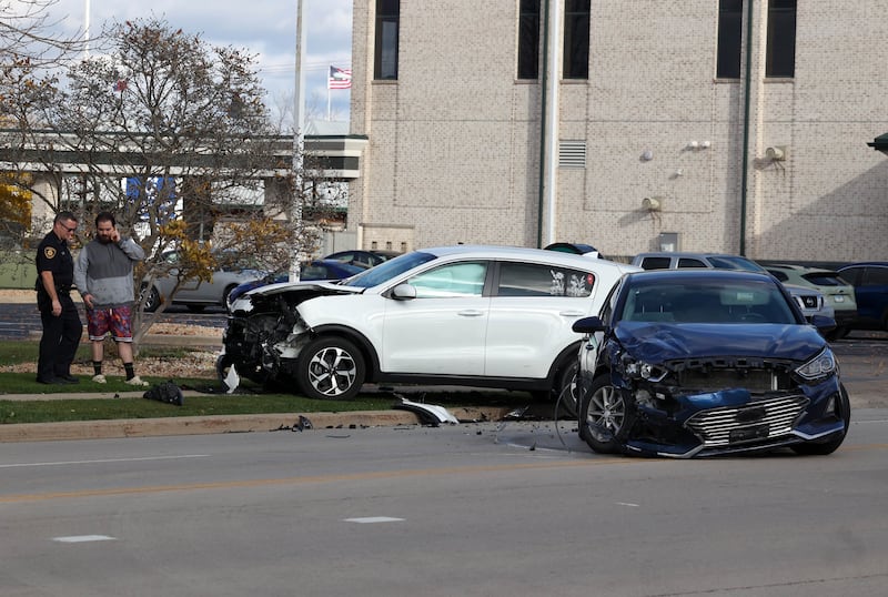 DeKalb County Sherriff Andy Sullivan (left) who was first on the scene, talks to a man at a two vehicle crash Tuesday, Nov. 19, 2024, on Bethany Road near DeKalb Avenue in Sycamore. Both vehicles sustained heavy front end damage.