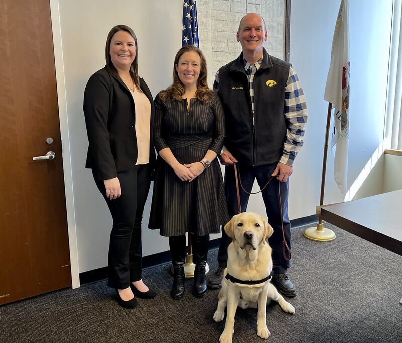 (Left to right) Kane County Child Advocacy Center forensic interviewer Sara Innocenti, State's Attorney Jamie Mosser and investigator Tom Ruzevich pose with DuoDog Captain after he was sworn in as KCCAC's first facility dog on Feb. 28, 2025 at the Kane County Judicial Center.