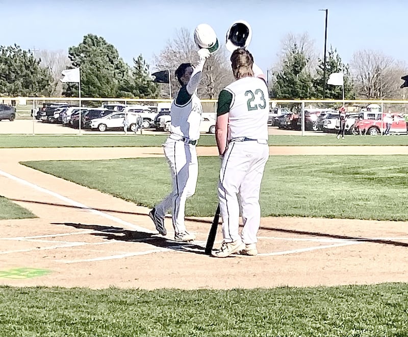 Gus Burr (left) is greeted by St. Bede teammate Maks Baker after hitting a first-inning home run to left field at Schweickert Stadium in Peru to give the Bruins an early 1-0 lead against Hall. The Red Devils came back for a 6-3 win.