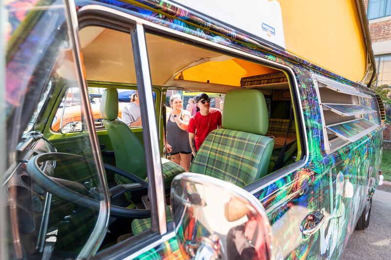 Riley Sus (right), checks out the inside of Jeffrey Tkachuk’s ’78 VW Westphalia Sunday, Aug. 25, 2024, at Amboy’s Depot Days. The camper van was wrapped in a colorful Grateful Dead motif.