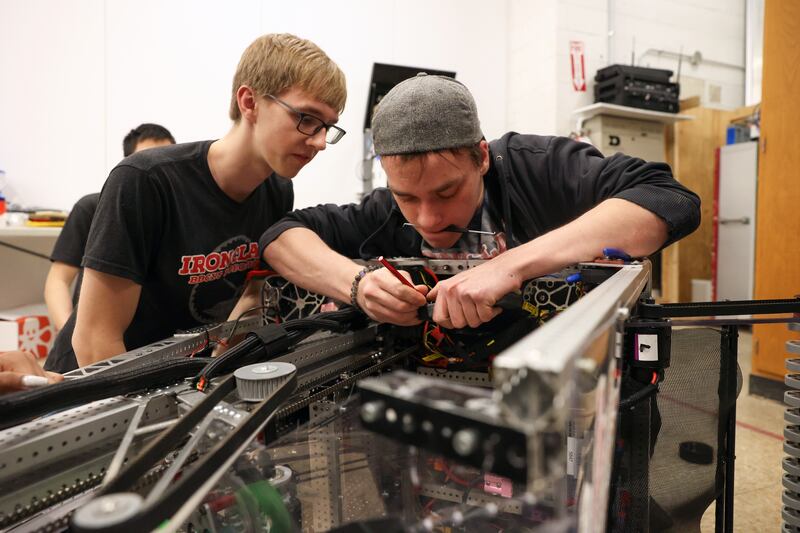Bradley-Bourbonnais junior Hunter Metzger, right, and senior Ben White modify an electrical component on the Ironclad Robotics' robot, Leviathan, which the team will compete with at an international competition, 2025 FIRST Championship, in Houston, Texas on April 16-19, after qualifying at regionals.