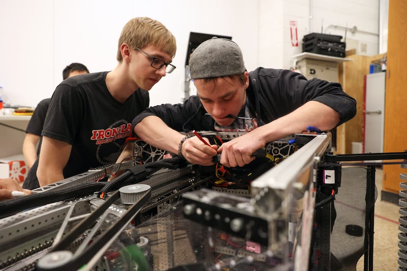Bradley-Bourbonnais junior Hunter Metzger, right, and senior Ben White modify an electrical component on the Ironclad Robotics' robot, Leviathan, which the team will compete with at an international competition, 2025 FIRST Championship, in Houston, Texas on April 16-19, after qualifying at regionals.