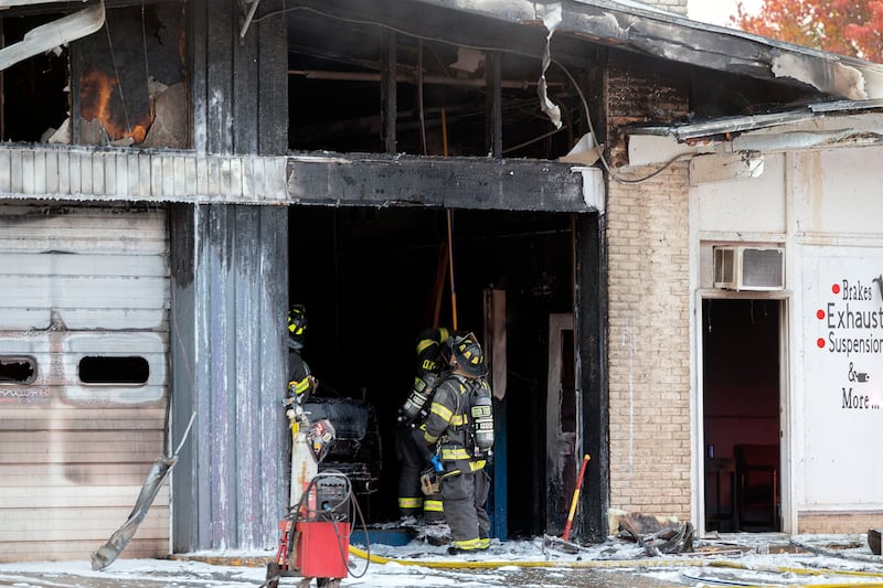 After dousing the fire with foam, firefighters look to check the ceiling for hot spots Friday, Nov. 7, 2025, in Sterling.