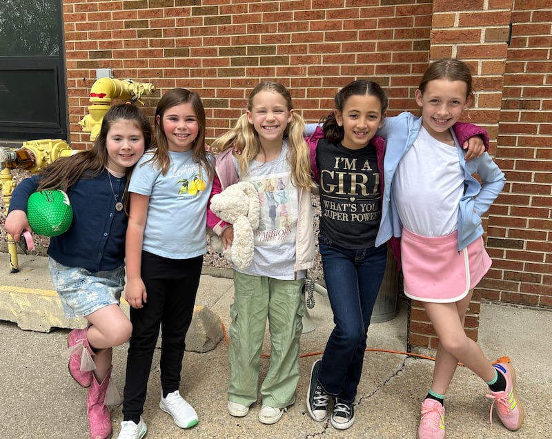 Children gather outside Immaculate Conception School in Morris on May 2, 2025. Participants in the out-of-uniform service project for charity.