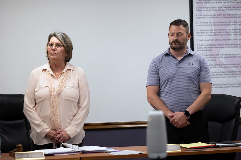 Dixon School Board members Linda Wegner and Brandon Rogers stand for the oath of office Tuesday, May 6, 2025.