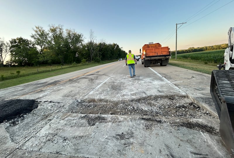 A crew from the Illinois Department of Transportation repairs one of two pavement blowouts on Illinois Route 2 Tuesday evening, July 1, 2025. The state highway was closed between Oregon and Byron as crews patched the roadway. This blowout was just north of Silver Ridge Golf Course.