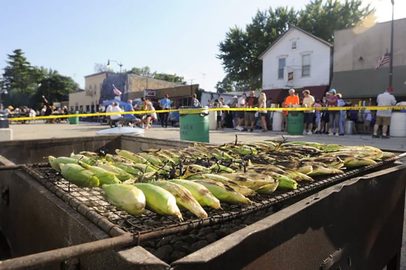 Ears of sweet corn roast over the grill along Main Street in Herscher during the annual Corn Bowl.