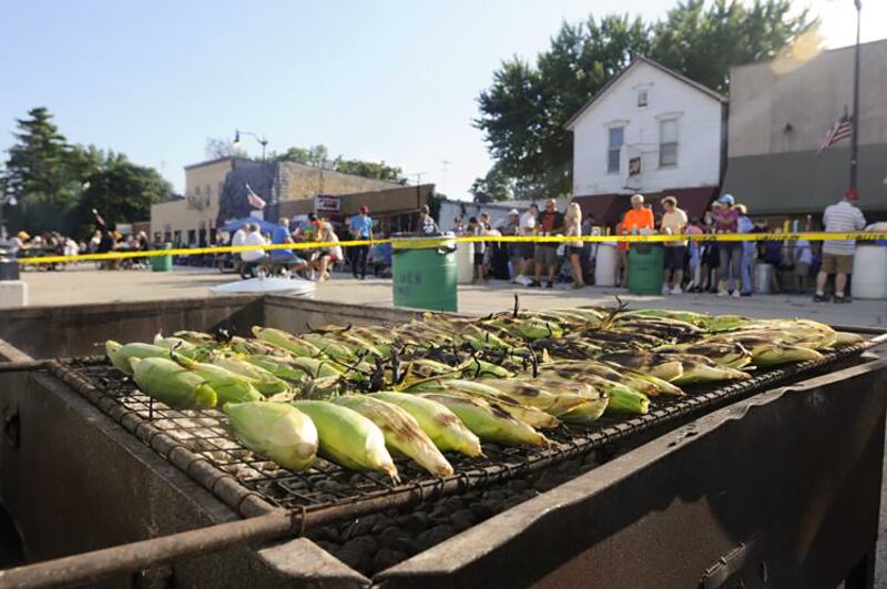 Ears of sweet corn roast over the grill along Main Street in Herscher during the annual Corn Bowl.