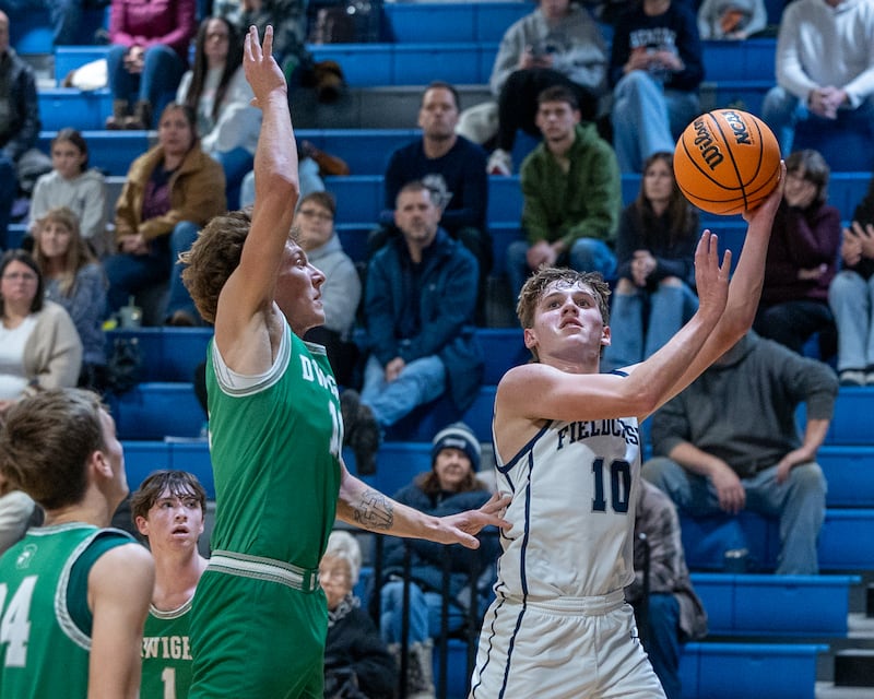 Kash Klendworth (10) of Fieldcrest lays up ball as Joey Starks (11) of Dwight leaps in attempt to contest on Monday, December 15, 2025 at Fieldcrest High School in Minonk.