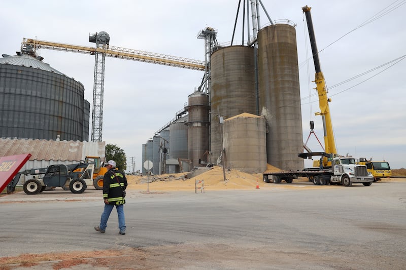 Martinton Fire Chief Jeff Meyer walks the scene following a concrete grain bin collapse on Wednesday, Oct. 15, 2025, at the Donovan Farmers Co-Op Elevator in downtown Martinton.