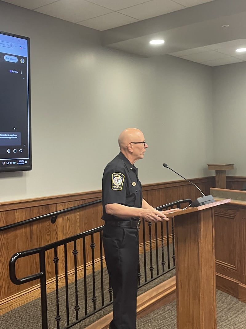 Lt. Doug Bernabei reads Monday, April 20, 2026. a farewell letter from Joe Hogan, longtime broadcaster, announcing his retirement from the city's 911 board.