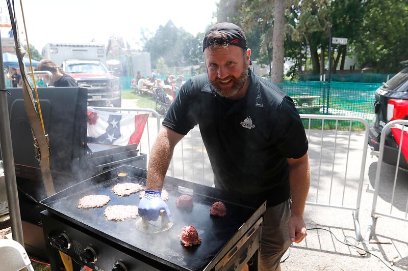 Kevin Byrnes, of Smash’D, cooks a smashed burger during Lakeside Festival on Friday, July 5, 2024, at the Dole.