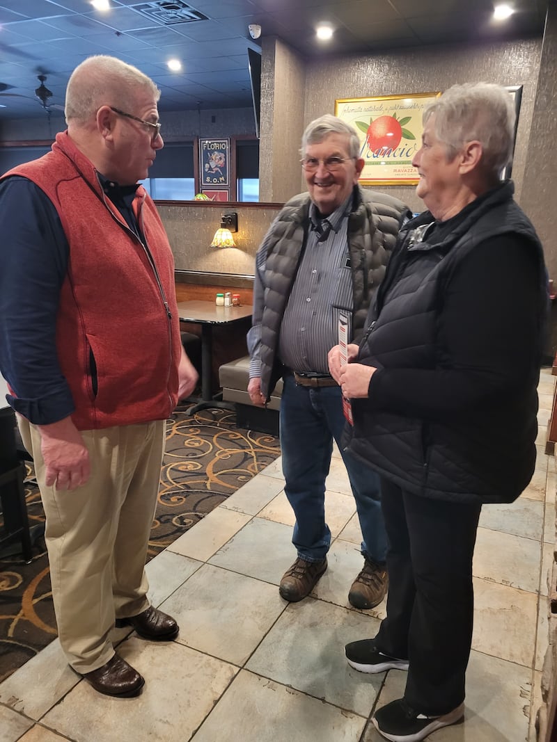 Illinois gubernatorial candidate Darren Bailey (left) visits with residents Wednesday, Jan. 21, 2026, during a campaign stop in Sterling.