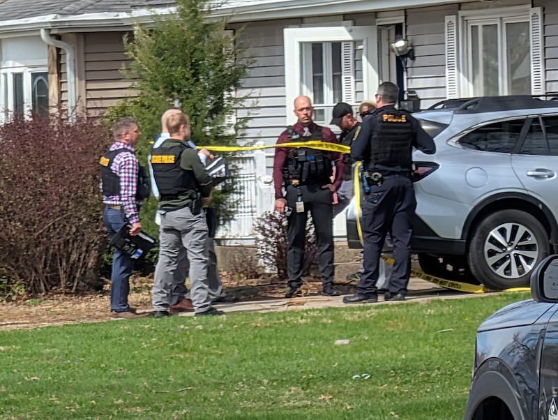 Investigators talk outside the home on Jonette Avenue where a homicide occurred April 8, 2026.