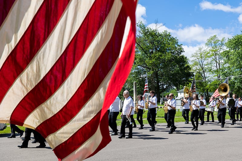 The Dixon Municipal Band marches into Oakwood Cemetery Monday, May 27, 2024 for a ceremony in recognition of Memorial Day.