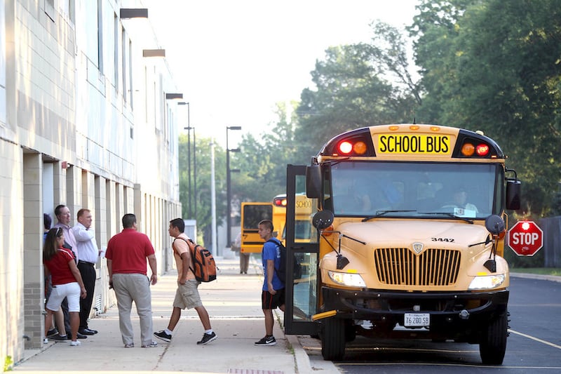 Batavia High School students exit their bus and head into the building for the first day of school Monday morning.
