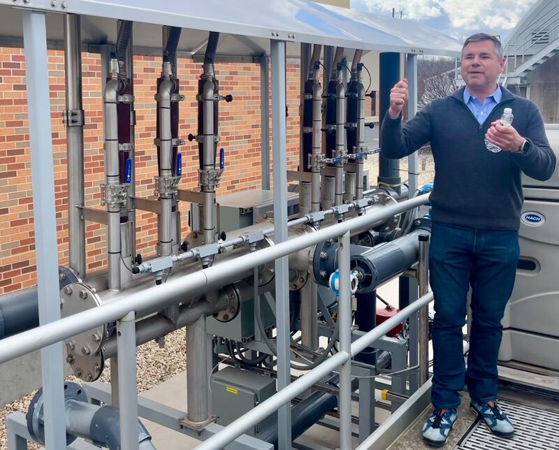 Cyrus McMains, executive director of the Yorkville-Bristol Sanitary District, demonstrates the innovative tech, the zeeDENSE water hydrocyclone by Veolia, that in combination with a molecular aerator, helps increase the amount and efficiency of the 'bugs' that treat the wastewater. The groundbreaking tech helped the facility save $19 million in expansion costs.
