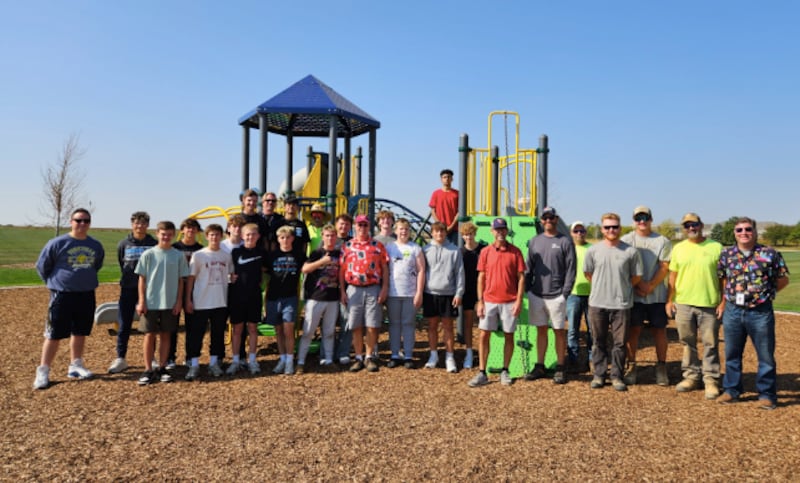 Yorkville Mayor John Purcell joins parks and recreation staff and volunteers from Yorkville Christian High School to celebrate the completion of Prestwick Park Playground in Yorkville in Oct. 2025.