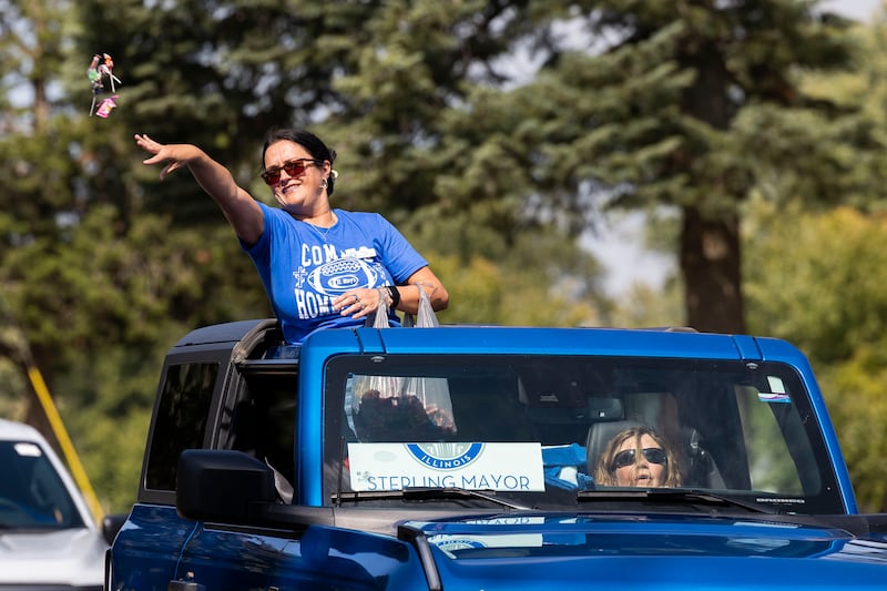 Sterling mayor Diana Merdian throws candy Friday, Sept. 12, 2025, while celebrating Newman High School’s homecoming parade.