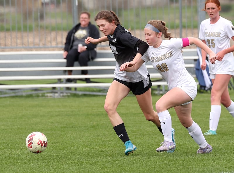 Kaneland's Erin Doucette (left) and Sycamore's Cortni Kruizenga go after the ball Wednesday, April 30, 2025, during their game at Kaneland High School in Maple Park.