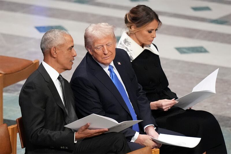 FILE - Former President Barack Obama talks with then President-elect Donald Trump as Melania Trump reads the funeral program before the state funeral for former President Jimmy Carter at Washington National Cathedral in Washington, Jan. 9, 2025. (AP Photo/Jacquelyn Martin, File)