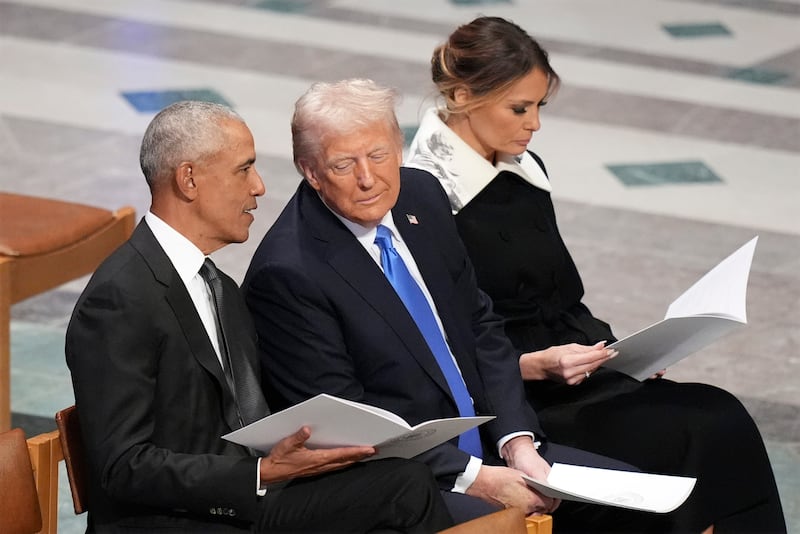 FILE - Former President Barack Obama talks with then President-elect Donald Trump as Melania Trump reads the funeral program before the state funeral for former President Jimmy Carter at Washington National Cathedral in Washington, Jan. 9, 2025. (AP Photo/Jacquelyn Martin, File)