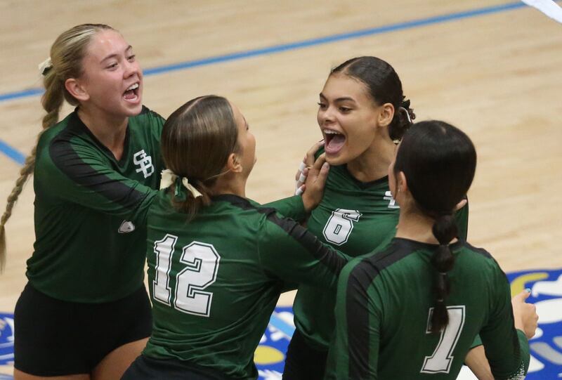 St. Bede players (from left) Nelle Potthoff, Lila Koehler, Kijah Lucas and Kate Duncan react after scoring a point against Marquette on Thursday, Sept. 4, 2025 at Bader Gym.