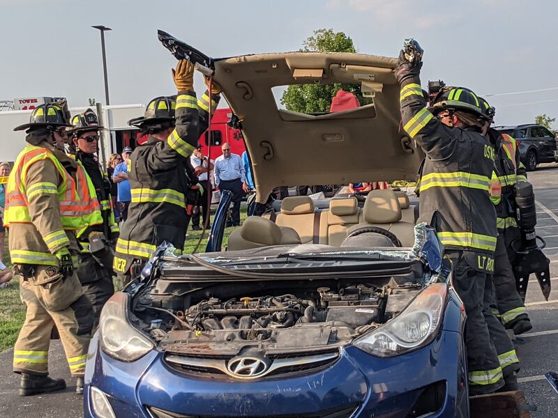 Firefighters with the Oswego Fire Protection District participate in a vehicle extrication demonstration during National Night Out on Aug. 5 at the Prairie Point Community Park in Oswego.