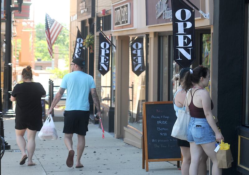 People shop on Woodstock Square in 2022. Merchandise could become more expensive in Woodstock as officials consider a sales tax increase.