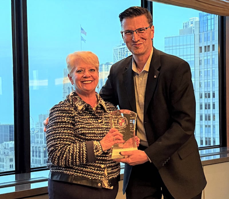 On behalf of Morris Hospital & Healthcare Centers, Morris Hospital Vice President of Patient Care Services and Chief Nurse Executive Kimberly Landers accepts the 100-Year Membership Award from American Hospital Association Regional Executive Alex Rozenbaum.