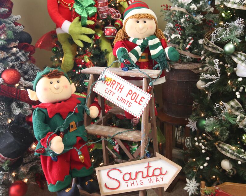 A view of elves and other Christmas on top of a antique ladder on Tuesday, Nov. 12, 2024 at Upscale Resale in Spring Valley.  For over 17 years the business has hosted a yearly Christmas Tree and Decor Auction, featuring unique items and themed trees that customers can add to their collections. The items will be on display in the window of the business, located at 214 W. St. Paul St. in Spring Valley. The auction takes place Thursday from 10a.m.-2p.m. Proceeds from the auction will go toward Upscale’s Helping Hands Charity to help out local communities.