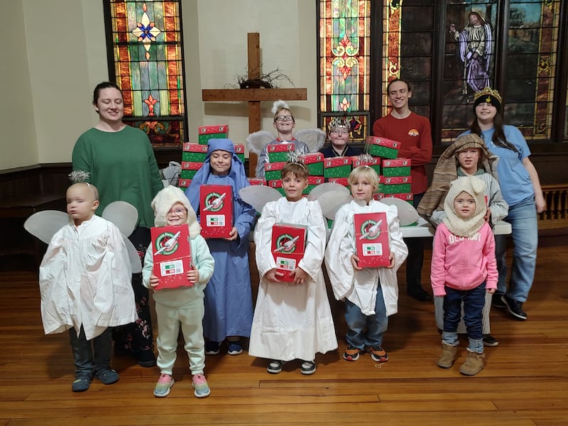 The Plano Methodist Church Sunday School staff and children with the Operation Christmas Child boxes.