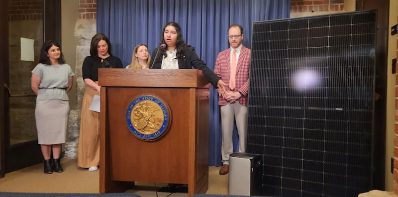 Kavi Chintham of Voter Solar gestures at a 391-watt plug-in solar panel and battery at a Thursday news conference about a bill to expand access to plug-in solar panel systems.