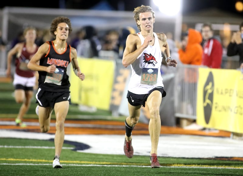 Yorkville’s Owen Horeni runs to the finish of the boys varsity race during the Naperville North Twilight Cross Country Invitational on Wednesday, Oct. 9, 2024 in Naperville.