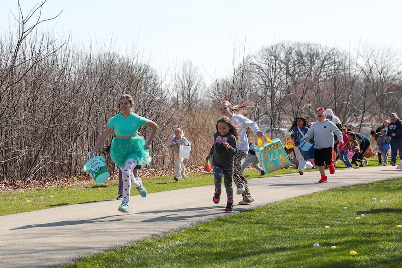 Children race along the path into Perry Farm Park with hopes to collect as many of the 12,000 prize-filled, plastic eggs as possible during the annual Easter Egg Hunt on Saturday, April 12, 2025.