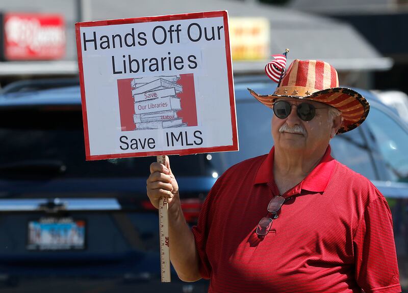 Tony Casalino of Woodstock protests along Route 31 in front of the McHenry Public Library on Friday, June 20, 2025, during a Save Our Libraries Protest hosted by Indivisible McHenry County to draw attention to cuts to the nation’s libraries by the Trump administration.