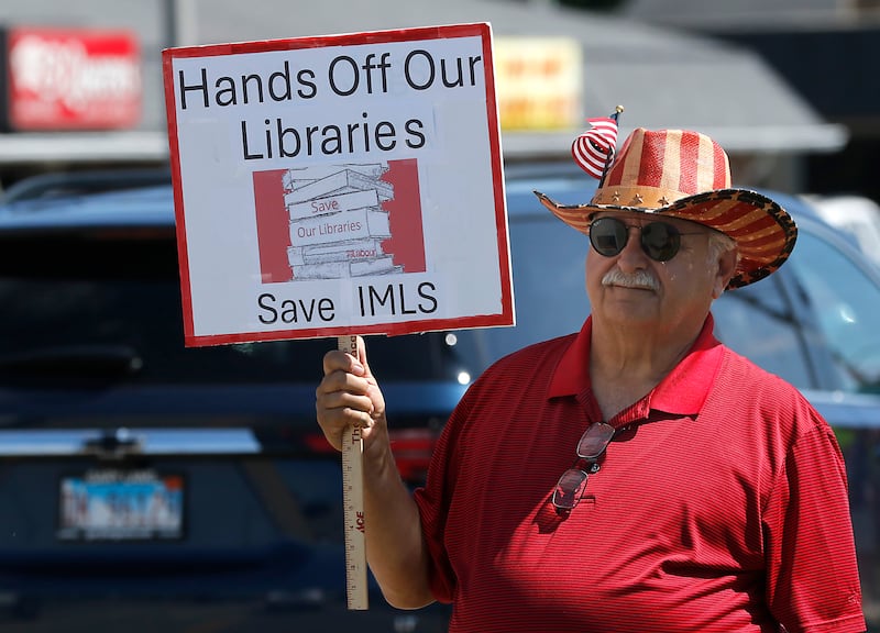 Tony Casalino of Woodstock protests along Route 31 in front of the McHenry Public Library on Friday, June 20, 2025, during a Save Our Libraries Protest hosted by Indivisible McHenry County to draw attention to cuts to the nation’s libraries by the Trump administration.