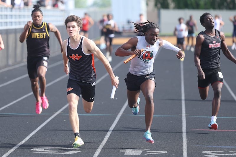 Minooka’s Blake Larson beats out Plainfield East’s Joe Owusu in the 4x100 Meter Relay in the Southwest Prairie Conference boys track and field championship on Wednesday, May 13, 2026 at Joliet West High School.