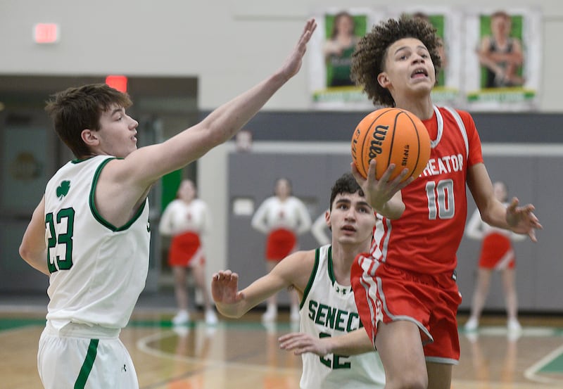 Streator’s Christian Bruton gets past Seneca’s Brady Sheedy for a layup in the 1st period Tuesday at Seneca.