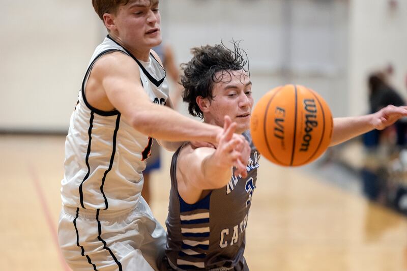 Newman’s Garret Matznick is fouled by Byron’s Ben Hively Friday, Dec. 19, 2025, in the Forreston Holiday Tournament title game.