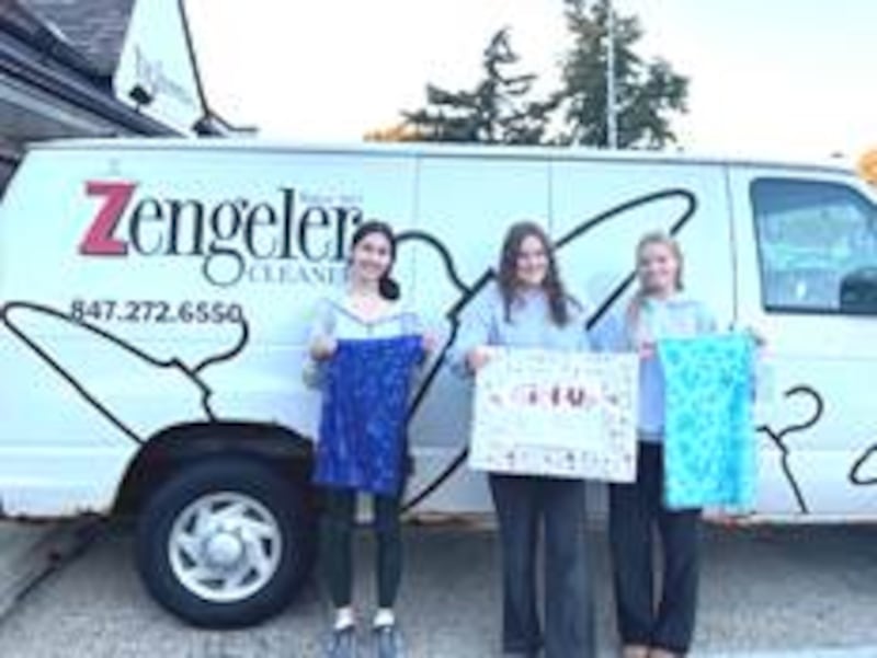 Highland Park High School students (left to right) Penelope Kappel, Eva Bender and Sadie Flynn deliver some of the first donations for this year’s collection drive to Zengeler Cleaners’ Hubbard Woods store. The collection drive continues through spring break for most participating schools.