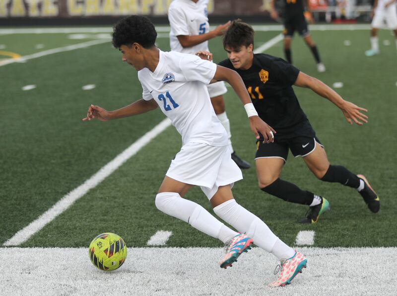 Woodstock's Eddie Hernandez controls the ball in front of Richmond-Burton’s Nick Kyes during a Kishwaukee River Conference soccer match on Wednesday, Sept. 10, 2025, at Richmond-Burton High School, in Richmond.