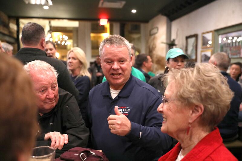 Clint Hull (center), candidate for St. Charles Mayor, visits with supporters while awaiting election results at McNally’s Irish Pub on Tuesday, April 1, 2025 in St. Charles.
