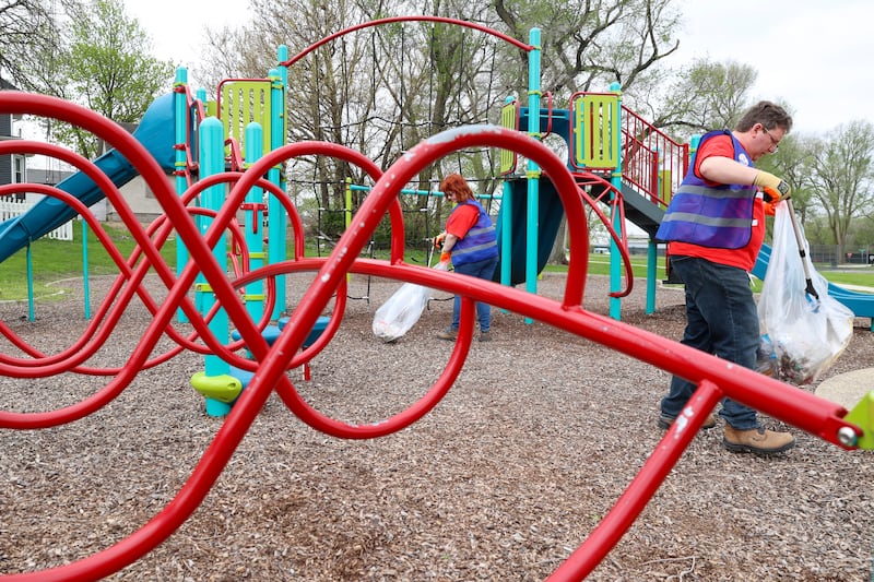 Volunteers Lisa Hassett, left, and Nicholas Scocozzo, with Dow Chemical in Kankakee, clean up Washington Park during the United Way of Kankakee & Iroquois Counties’ annual Day of Action on Wednesday, April 22, 2026.