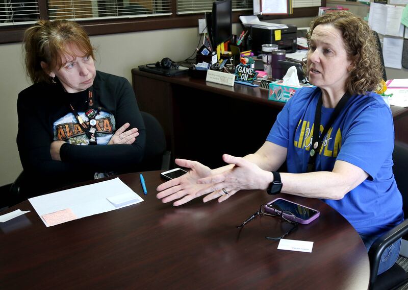 Tracy Beling, (right) a reading specialist at Lincoln Elementary School, talks as Christal Egel, a media center assistant, looks on Friday, March 21, 2025, at the school in DeKalb, about their experience at a winter educators conference in Alaska where they learned about the Iditarod dog sled race held annually there. The two educators were able to bring back what they learned to set up curriculum related to the race.