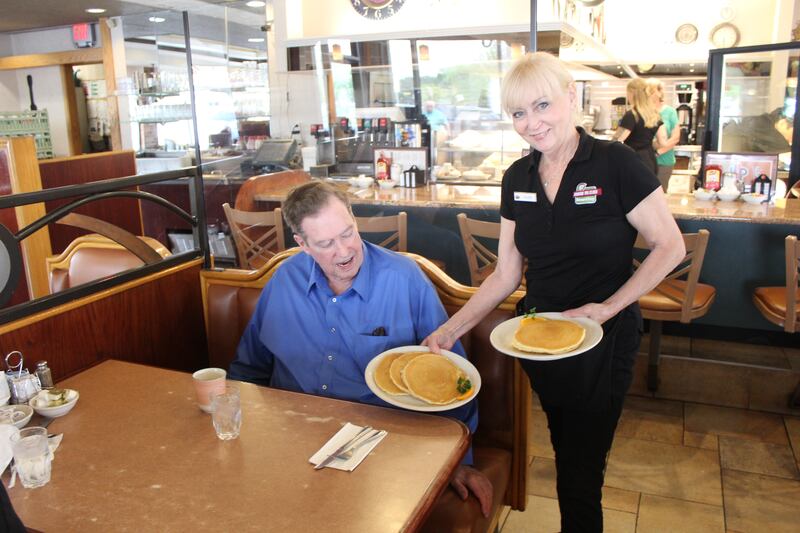 Around the Clock waitress Eileen Kozlowski serves pancakes to loyal customer Jack Shields on May 15, 2025.