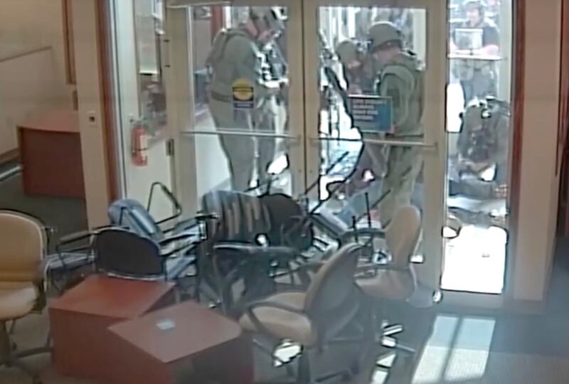 SWAT members with Will County Sheriff's Office storm the vestibule of Fifth Third Bank on May 10, 2022, in Romeoville, after Gregory Walker, 65, of Crest Hill, was fatally shot by Will County Sheriff's Lt. John Allen.
