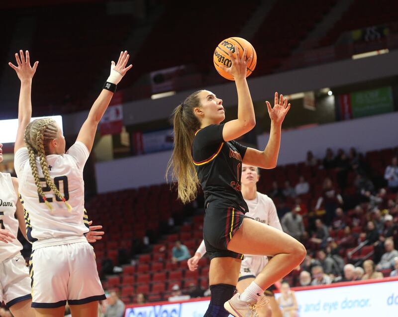 Montini's Nikki Kerstein eyes the hoop while getting by Quincy Notre Dame's Ari Buehler during the Class 3A State semifinal game on Thursday, March 6, 2025 at CEFCU Arena in Normal.